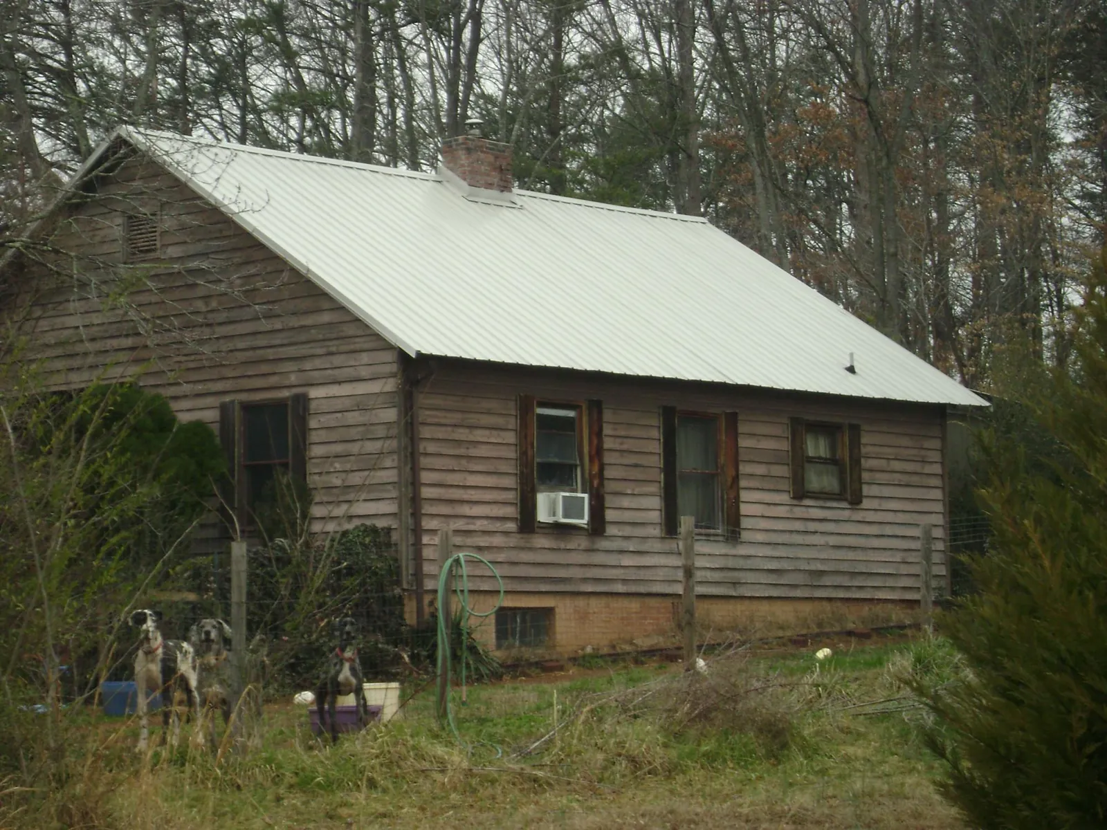 White metal roof on an old wood sided farmhouse, from a Metal Roof Installation job in Westborough